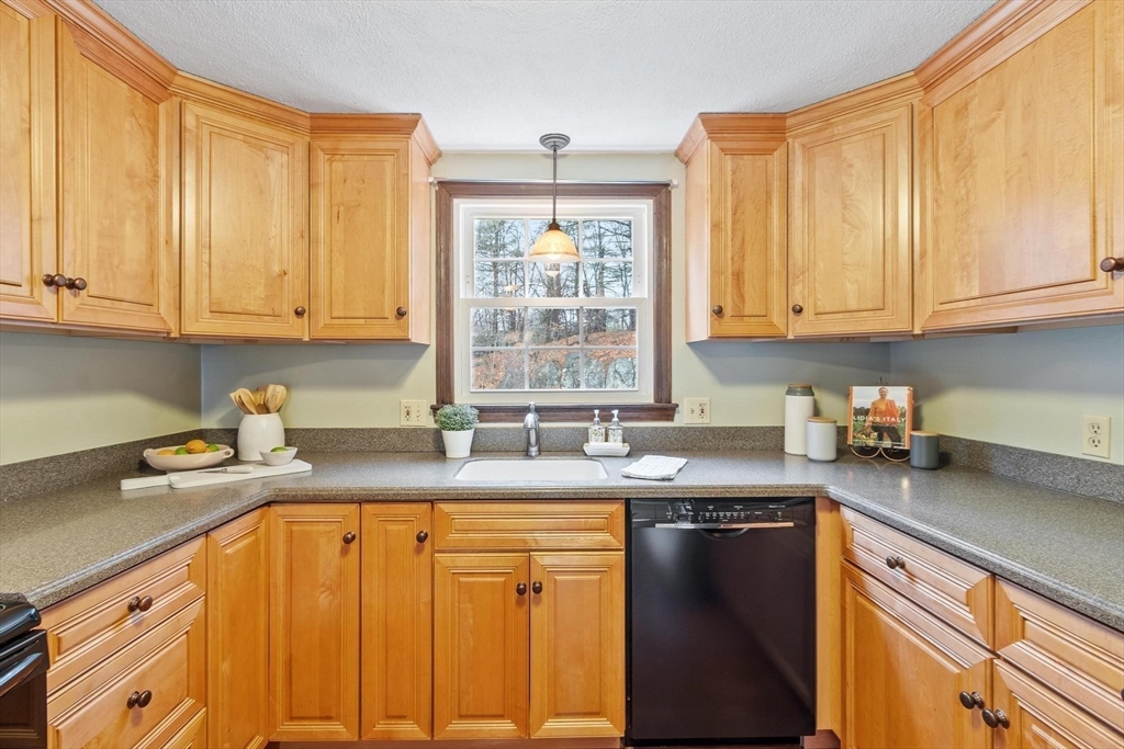 61 Beaver Road Reading, MA 01867 - Photo 13 of 39 a kitchen with stainless steel appliances granite countertop a sink a stove a counter space and cabinets