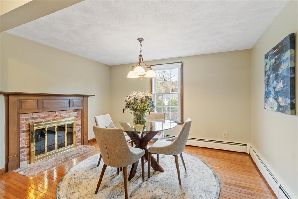 61 Beaver Road Reading, MA 01867 - Photo 15 of 39 a dining room with furniture a chandelier and wooden floor