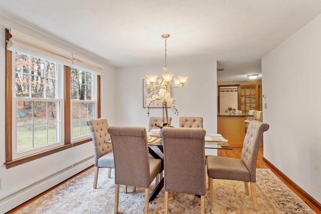 61 Beaver Road Reading, MA 01867 - Photo 17 of 39 a dining room with furniture window and wooden floor