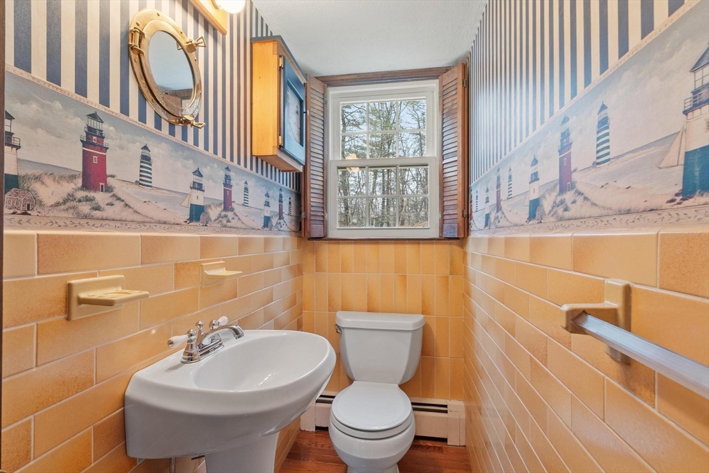 61 Beaver Road Reading, MA 01867 - Photo 18 of 39 a bathroom with a sink a toilet and a mirror