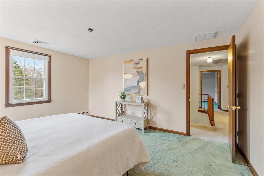 61 Beaver Road Reading, MA 01867 - Photo 22 of 39 a bedroom with a bed and a table