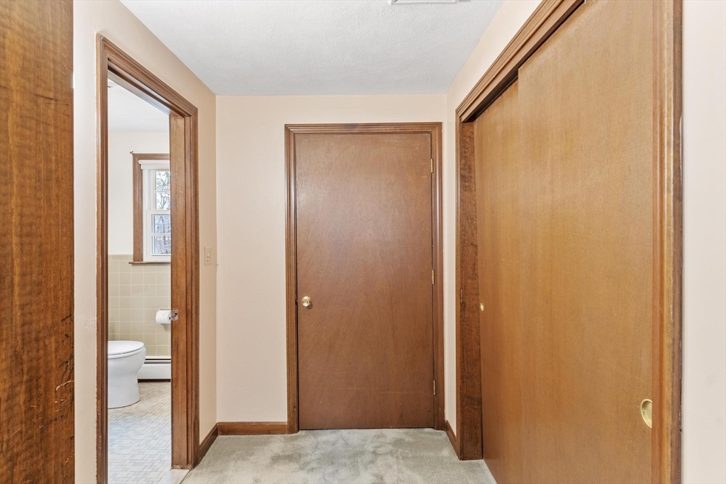 61 Beaver Road Reading, MA 01867 - Photo 24 of 39 a view of hallway with bathroom and front door
