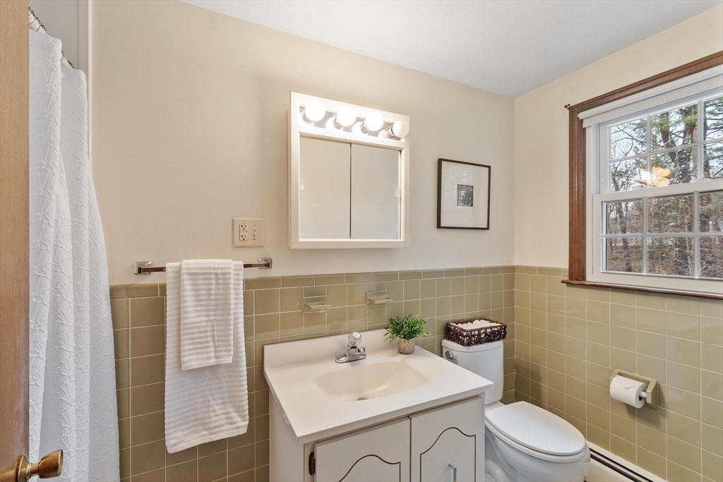 61 Beaver Road Reading, MA 01867 - Photo 25 of 39 a bathroom with a sink toilet and mirror