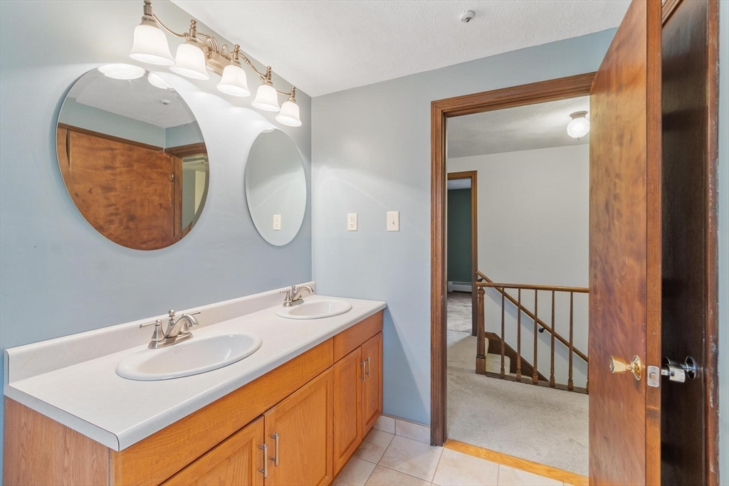 61 Beaver Road Reading, MA 01867 - Photo 27 of 39 a bathroom with a sink and a mirror