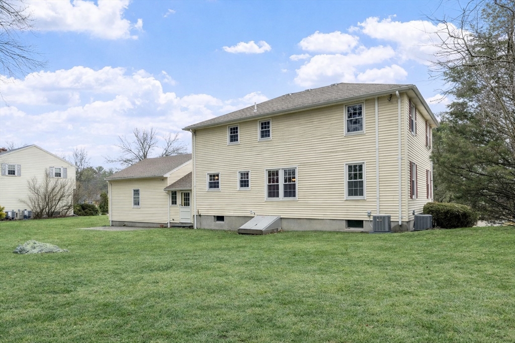 61 Beaver Road Reading, MA 01867 - Photo 35 of 39 a front view of a house with a garden