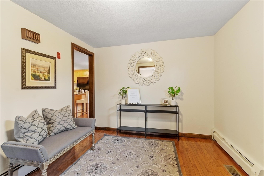 61 Beaver Road Reading, MA 01867 - Photo 5 of 39 a living room with furniture and wooden floor