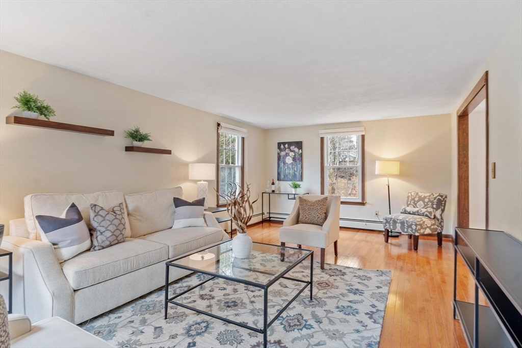 61 Beaver Road Reading, MA 01867 - Photo 7 of 39 a living room with furniture and a wooden floor