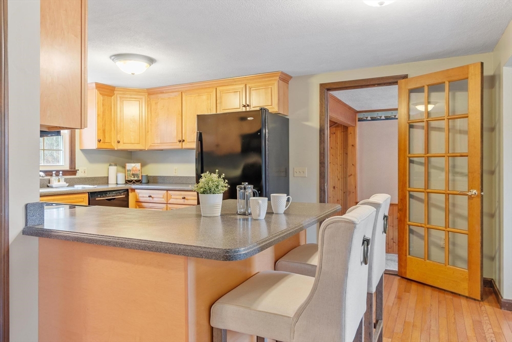 61 Beaver Road Reading, MA 01867 - Photo 9 of 39 a kitchen with stainless steel appliances granite countertop a sink a stove and a refrigerator