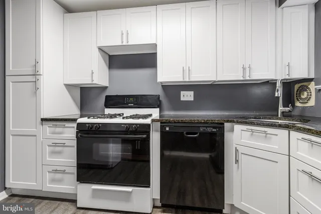 a stove top oven sitting inside of a kitchen