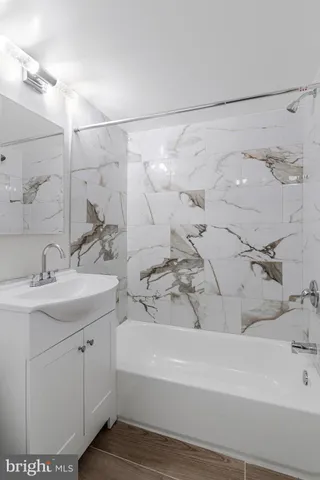 a bathroom with a bathtub and a sink