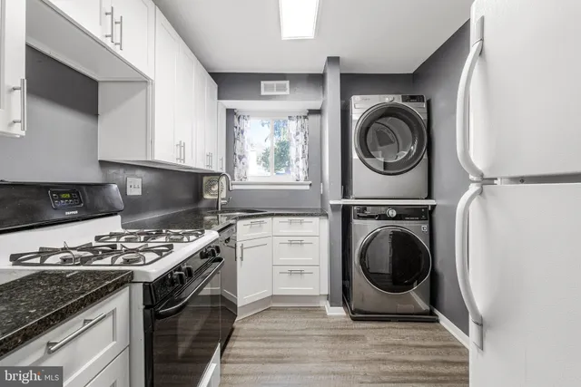 a kitchen with a stove a washer and dryer