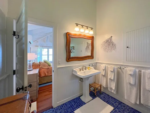 a bathroom with a sink mirror and toilet