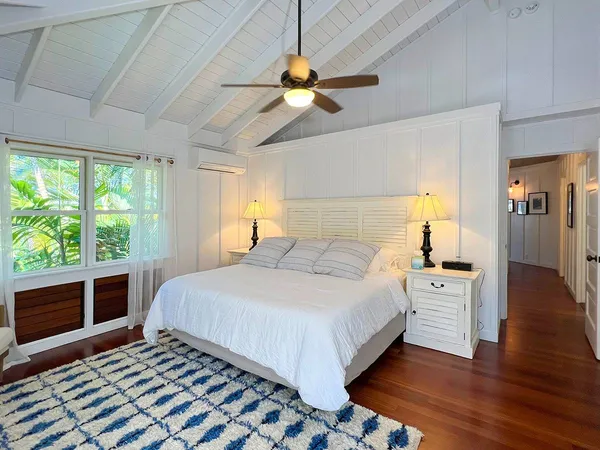 a bedroom with a large bed and a large window