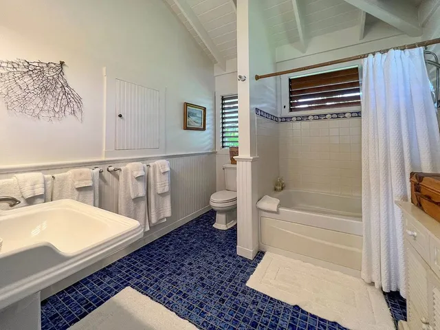 a spacious bathroom with a bathtub and shower