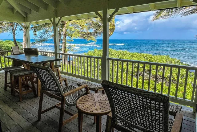 a view of a chairs and table in the balcony