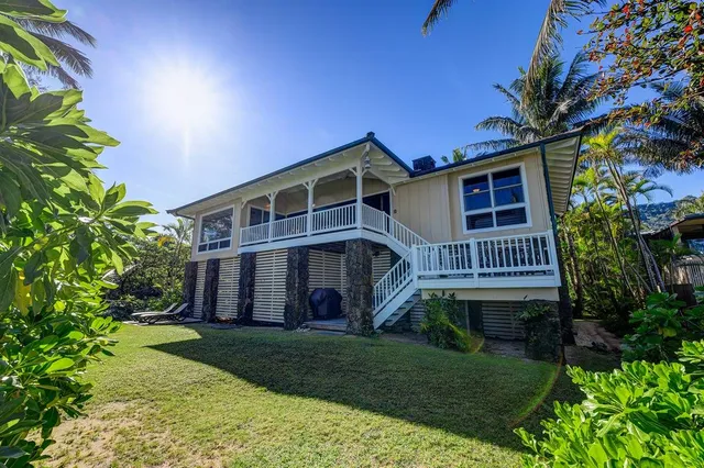 a view of a house with a yard and plants
