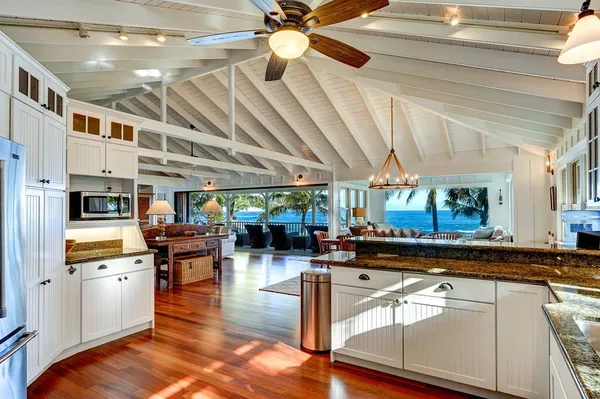 a living room with lots of furniture and kitchen view