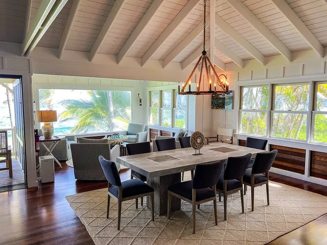 a dining room with furniture a chandelier and wooden floor