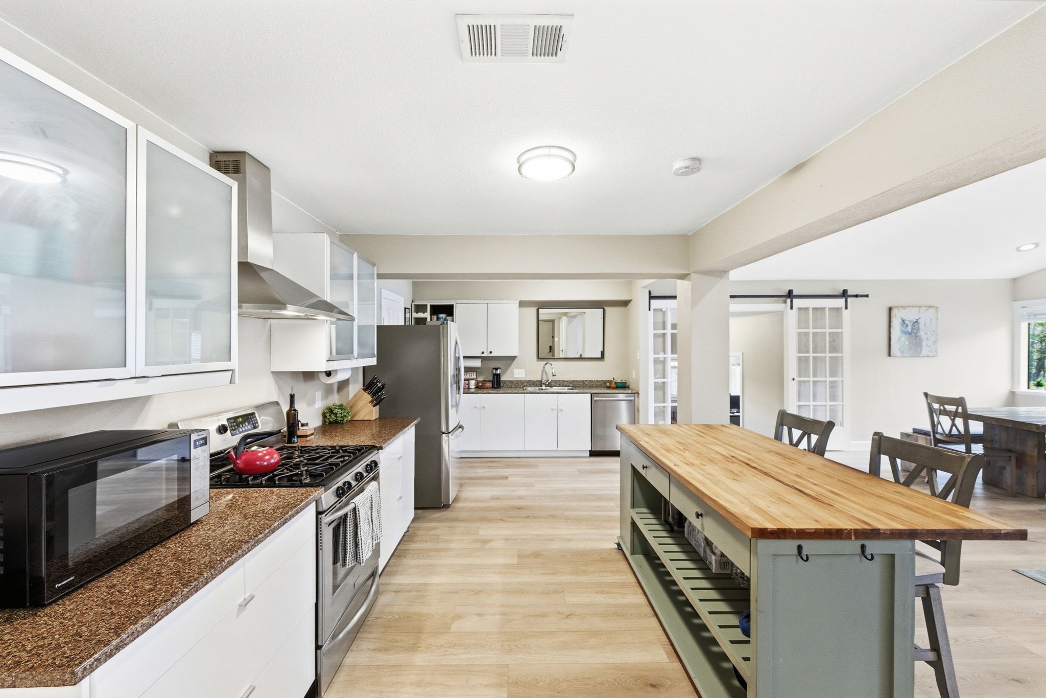 7210 Towering Oaks Drive Austin, TX 78745 - Photo 13 of 38 The kitchen boasts chic modern cabinetry, granite countertops, pantry storage, and desirable SS appliances.
