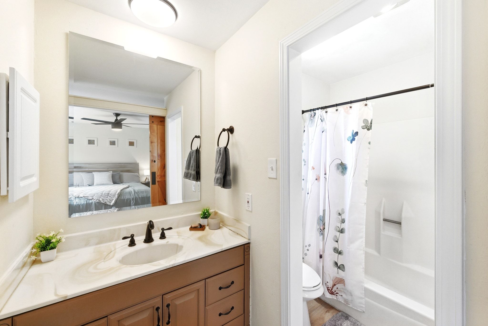 7210 Towering Oaks Drive Austin, TX 78745 - Photo 17 of 38 The primary ensuite bathroom features a vanity area flanked by the walk-in closet and wet room.