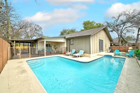 a view of a house with swimming pool having patio