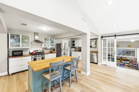 a view of a dining room with furniture and a kitchen