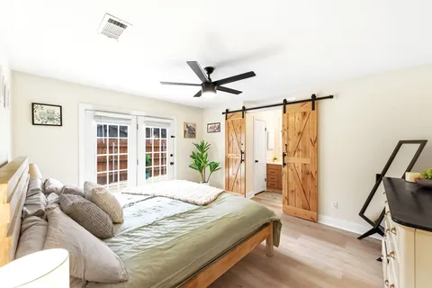 a bedroom with a bed and a large window