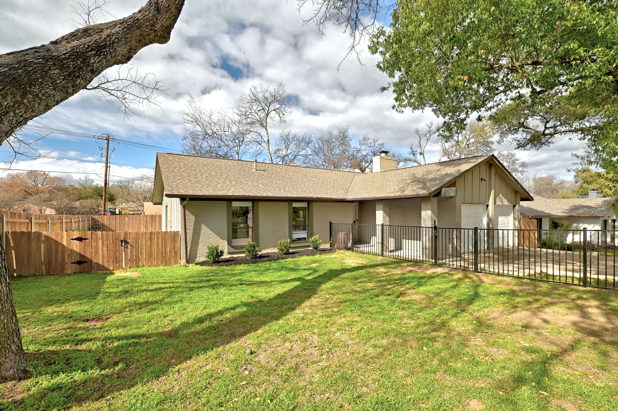 7210 Towering Oaks Drive Austin, TX 78745 - Photo 7 of 38 a front view of a house with a yard