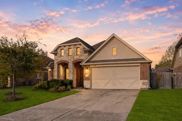 a front view of a house with a yard and garage