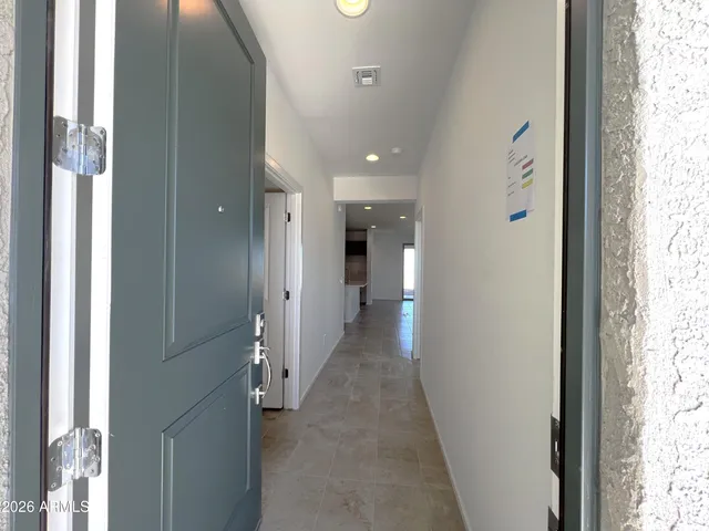 a view of a hallway with a window and a bathroom