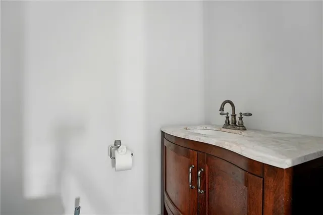a bathroom with a granite countertop sink and mirror