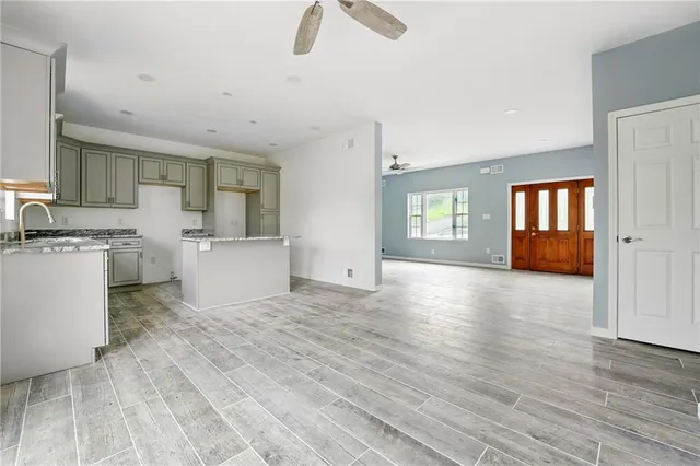 a view of a kitchen with a sink hardwood floor and a living room