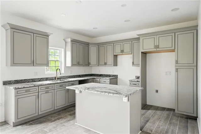 a kitchen with a sink a stove a refrigerator and cabinets