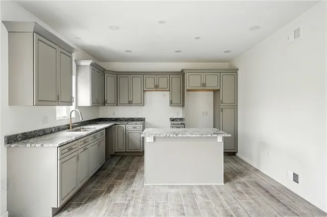a kitchen with a stove top oven and cabinets