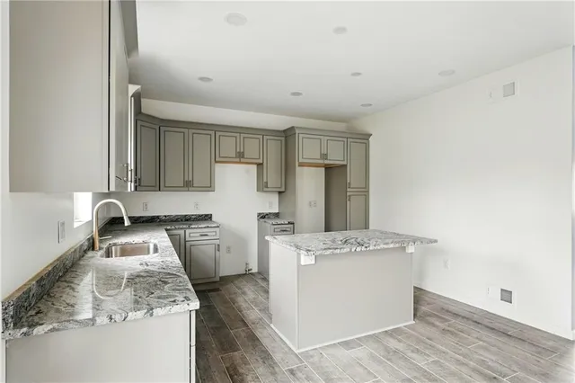 a kitchen with a stove a sink and a refrigerator