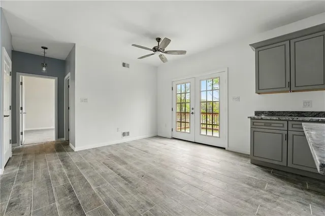a view of an empty room with a fireplace and a window