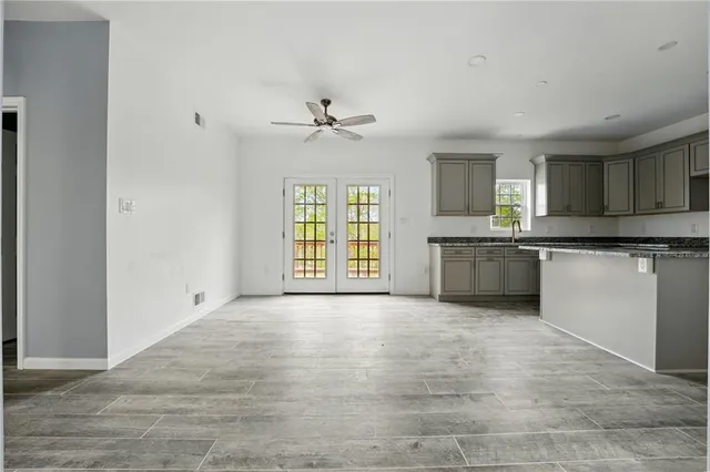 a view of a kitchen with granite countertop cabinets and stainless steel appliances