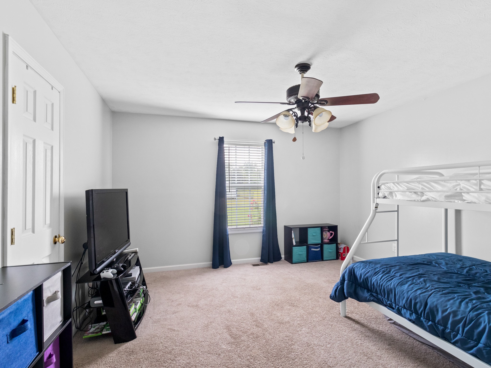 141 Sudberry Road Bell Buckle, TN 37020 - Photo 22 of 33 a bedroom with a bed and a chandelier