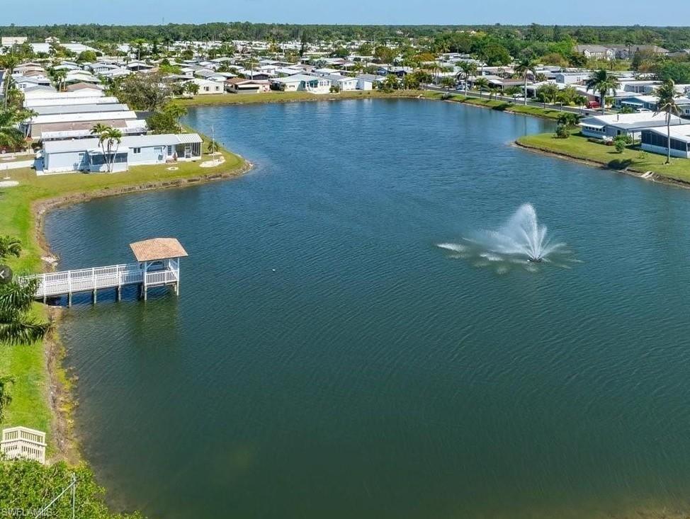 76 Atlantic Way, Unit 76 Naples, FL 34104 - Photo 3 of 18 Aerial perspective of suburban area with a large body of water