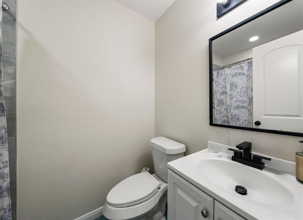 3109 North 27th Street Waco, TX 76708 - Photo 11 of 17 a bathroom with a sink a toilet and mirror