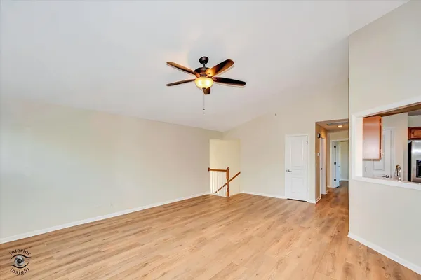 a view of a room with a sink and a chandelier fan