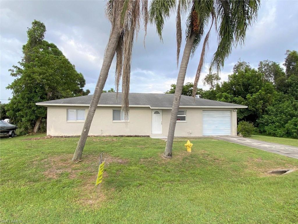 18457 Matanzas Road Fort Myers, FL 33967 - Photo 1 of 9 a house that has a tree in front of it