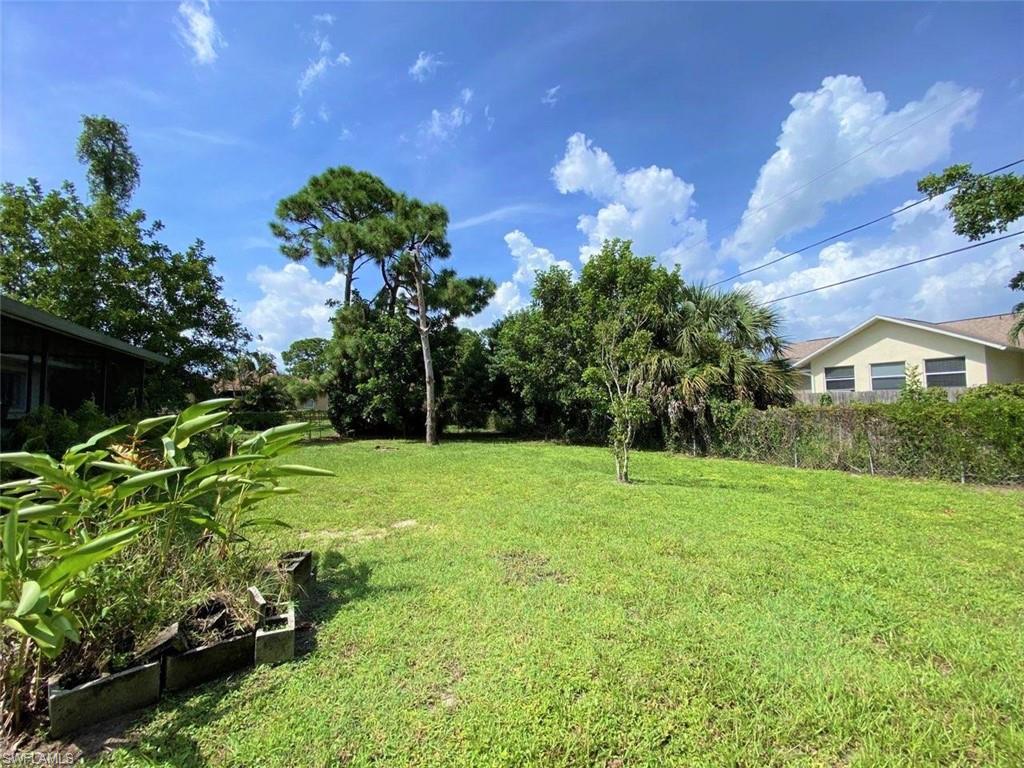 18457 Matanzas Road Fort Myers, FL 33967 - Photo 2 of 9 a backyard of a house with lots of green space and outdoor seating