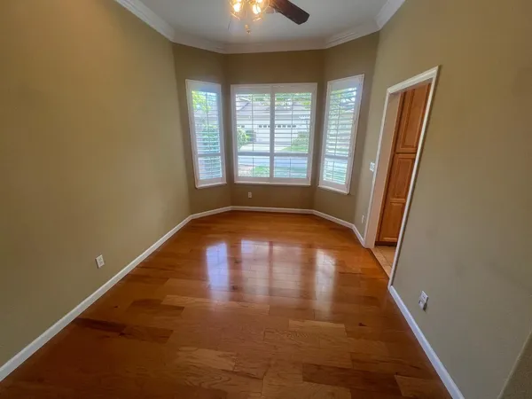 wooden floor in an empty room with a window