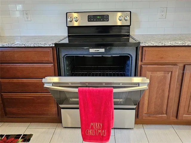 a stove top oven sitting inside of a kitchen