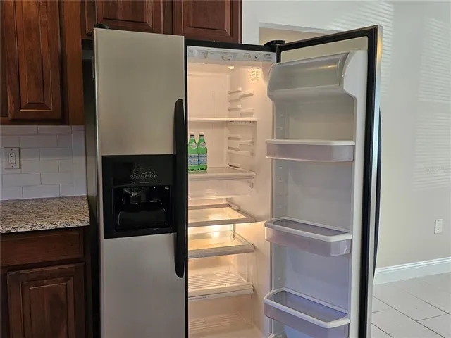 a bathroom with a granite countertop shower a sink and a stove