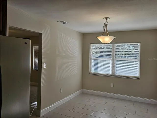 an empty room with a bathroom and a sink