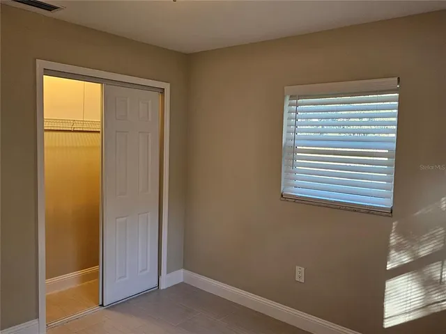 an empty room with window fan