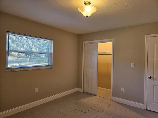a bathroom with a granite countertop toilet sink and mirror