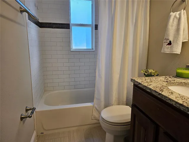 a kitchen with a sink a stove and cabinets